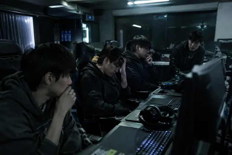 Team practice room with controllers, monitors, and open seats before scrims
